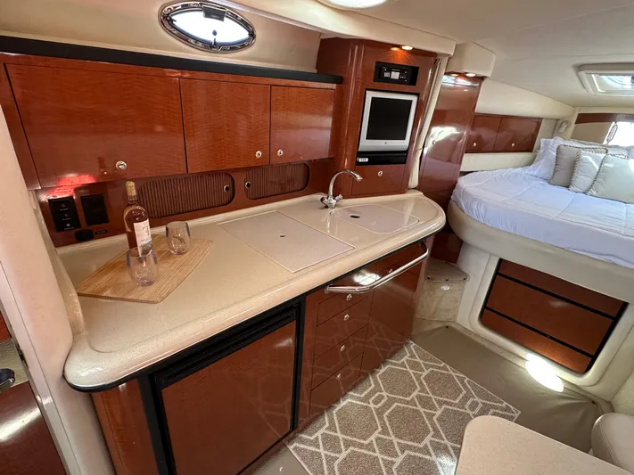  Yacht Photos Pics Interior of 2004 Sea Ray 340 Sundancer yacht with kitchenette and bed.