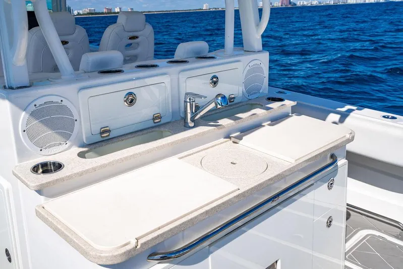 Batavia Yacht Photos Pics 2019 HCB 42 Siesta boat with sleek outdoor kitchen and ocean backdrop.