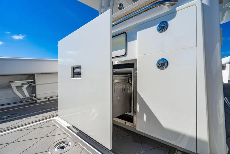Batavia Yacht Photos Pics 2019 HCB 42 Siesta boat interior with open storage compartment under clear blue sky.