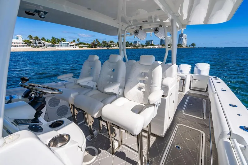Batavia Yacht Photos Pics 2019 HCB 42 Siesta boat interior with white seating, ocean view, and coastal background.