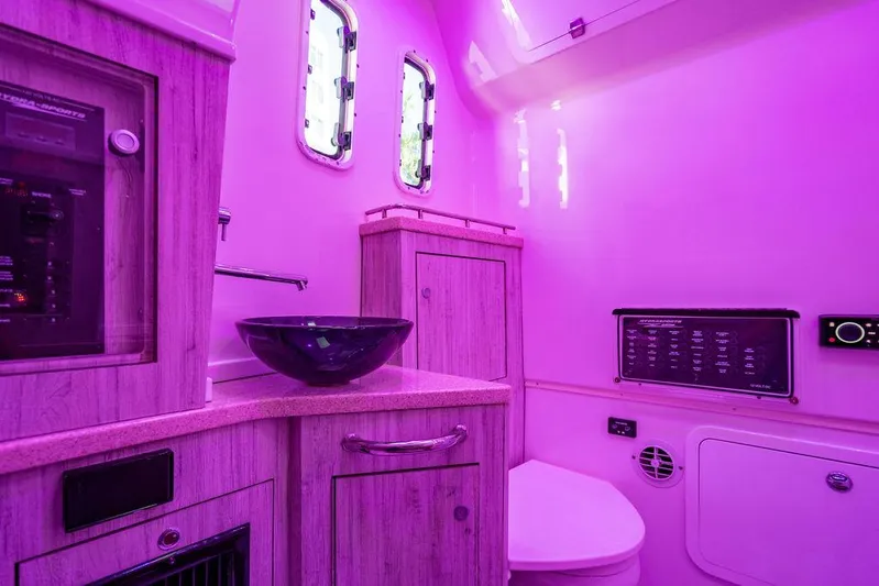 Batavia Yacht Photos Pics Luxurious 2019 HCB 42 Siesta boat bathroom with modern fixtures and ambient purple lighting.