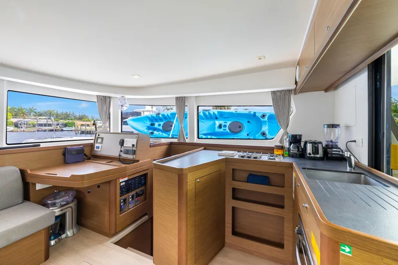 Benedetto Yacht Photos Pics Interior of 2020 Lagoon 42 catamaran with modern kitchen and navigation area.