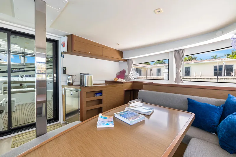 Benedetto Yacht Photos Pics Interior of 2020 Lagoon 42 catamaran with modern dining area and large windows.