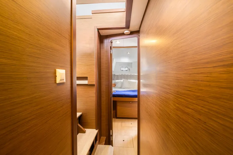 Benedetto Yacht Photos Pics Interior of 2020 Lagoon 42 yacht, featuring wooden paneling and a cozy cabin view.