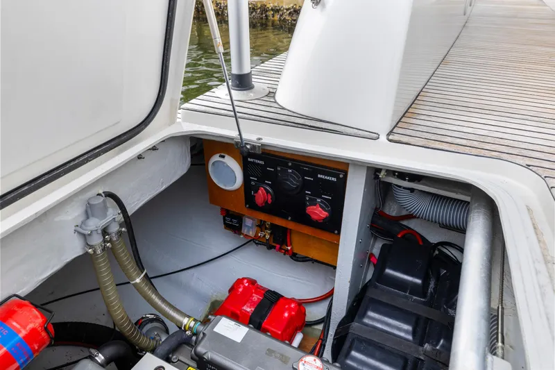 Benedetto Yacht Photos Pics Engine compartment of a 2020 Lagoon 42 catamaran, showcasing mechanical components and battery setup.