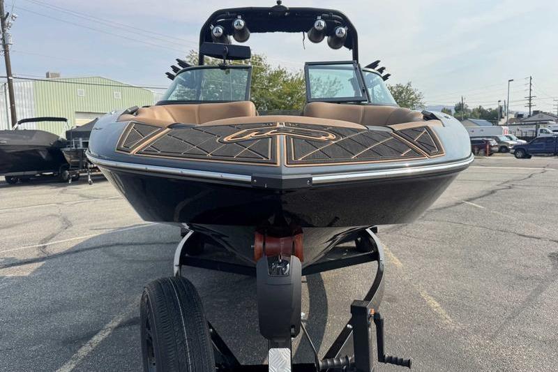 2024 MB Alpha 23 boat on trailer, front view in parking lot.