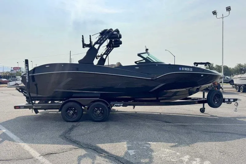 2024 MB Alpha 23 boat on trailer in parking lot.