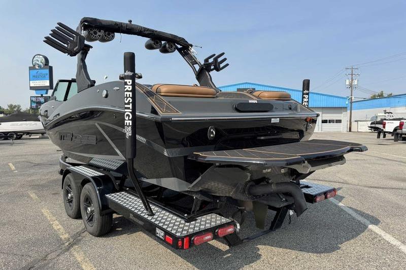 2024 MB Alpha 23 boat on trailer, parked outdoors, showcasing sleek design and modern features.