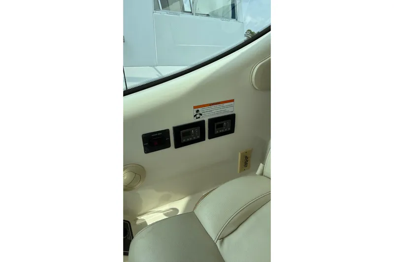  Yacht Photos Pics Control panel on 2007 Tiara Yachts 3900 Sovran interior, featuring switches and warning label.