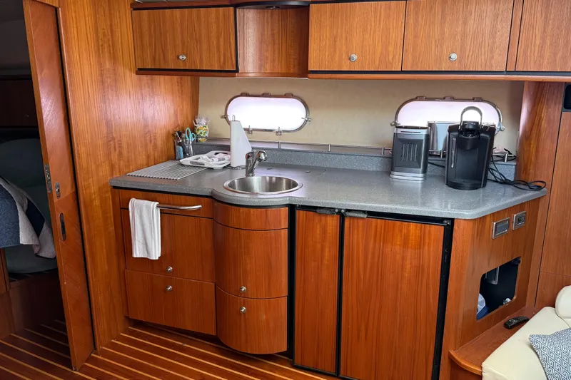  Yacht Photos Pics 2007 Tiara Yachts 3900 Sovran interior kitchen with wooden cabinets and modern appliances.