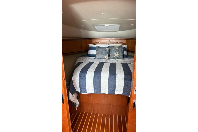 Yacht Photos Pics Luxurious cabin interior of 2007 Tiara Yachts 3900 Sovran with striped bedding.