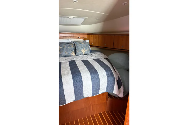  Yacht Photos Pics Cozy cabin interior of 2007 Tiara Yachts 3900 Sovran with striped bedding.