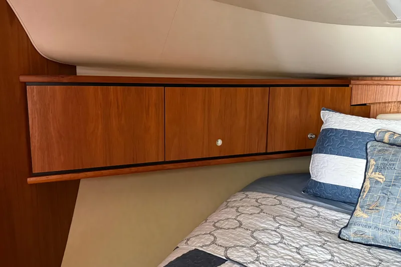  Yacht Photos Pics Interior of 2007 Tiara Yachts 3900 Sovran with wooden cabinets and cozy bedding.