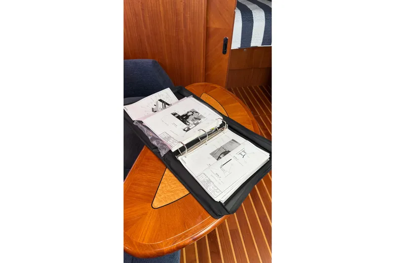  Yacht Photos Pics Open binder with yacht schematics on a wooden table, Tiara Yachts 3900 Sovran, 2007 model.