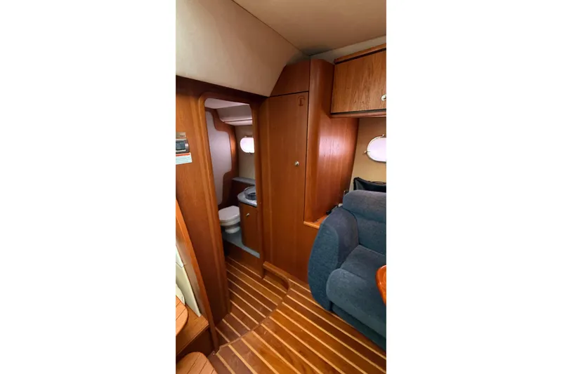  Yacht Photos Pics 2007 Tiara Yachts 3900 Sovran interior with wooden flooring and compact bathroom.