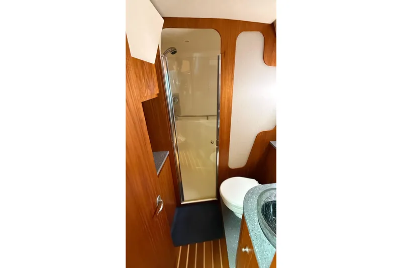  Yacht Photos Pics Luxurious bathroom in 2007 Tiara Yachts 3900 Sovran with wood accents and modern fixtures.