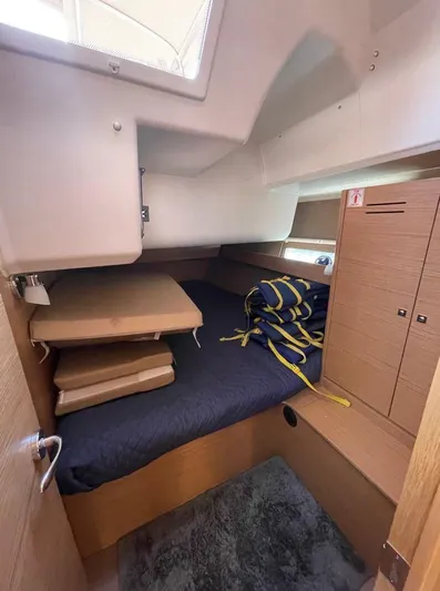 Stellar Yacht Photos Pics Cozy cabin interior of 2016 Dufour 460 Grand Large yacht with bed and storage.