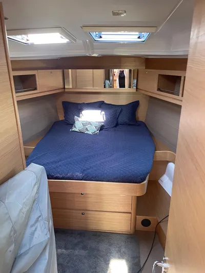 Stellar Yacht Photos Pics Interior cabin of 2016 Dufour 460 Grand Large yacht with cozy bed and wooden finish.