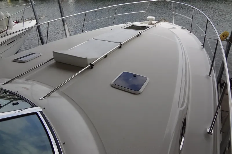 Shel 'b' Gale Yacht Photos Pics 2001 Sea Ray 380 Sundancer boat deck with railing, docked by the water.