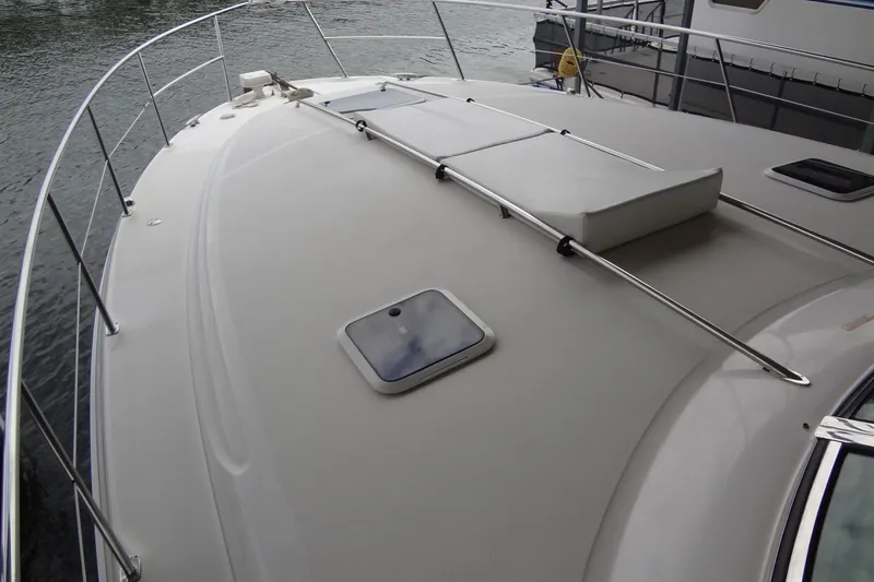 Shel 'b' Gale Yacht Photos Pics 2001 Sea Ray 380 Sundancer boat deck with railing and hatch, docked by water.