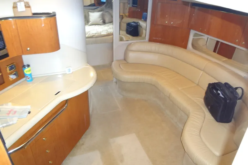 Shel 'b' Gale Yacht Photos Pics Interior of 2001 Sea Ray 380 Sundancer with beige leather seating and wooden cabinetry.