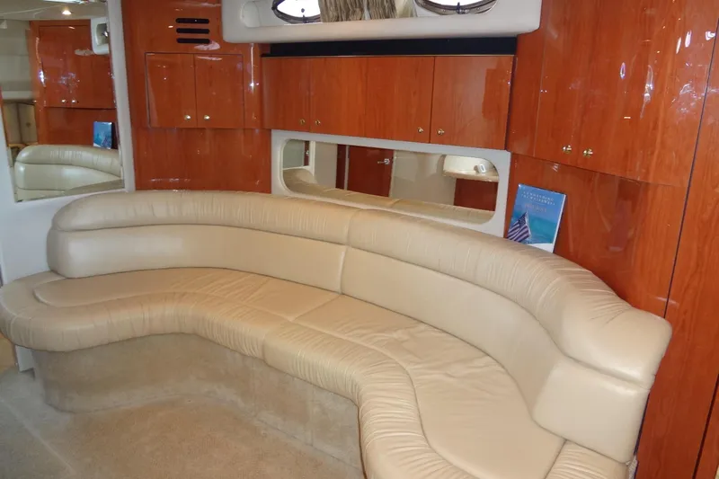 Shel 'b' Gale Yacht Photos Pics Luxurious interior of 2001 Sea Ray 380 Sundancer with beige leather seating and wooden cabinets.