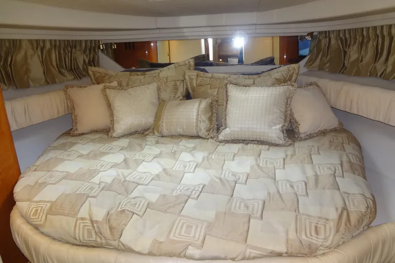 Shel 'b' Gale Yacht Photos Pics Luxurious cabin interior of 2001 Sea Ray 380 Sundancer with plush bedding and pillows.