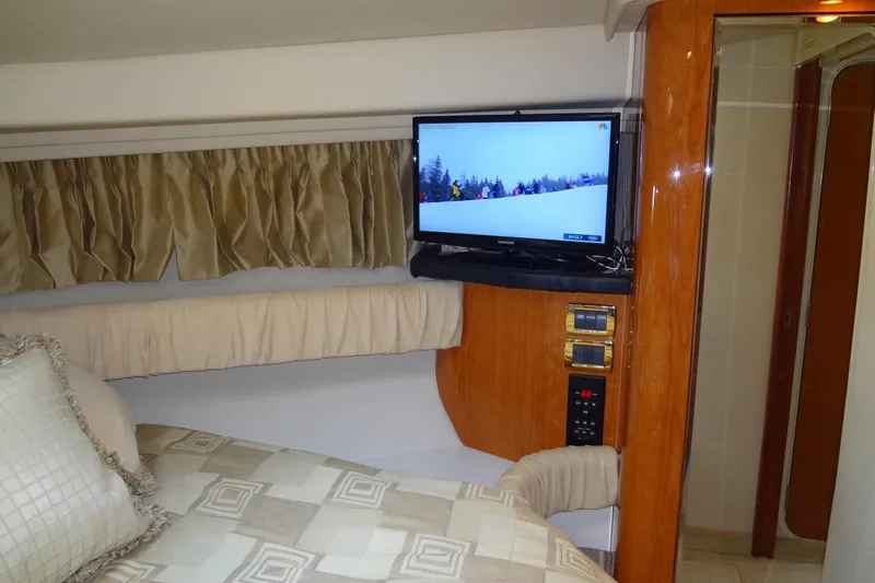 Shel 'b' Gale Yacht Photos Pics Interior of 2001 Sea Ray 380 Sundancer with TV, bed, and wood paneling.