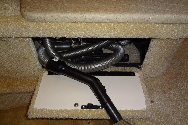 Shel 'b' Gale Yacht Photos Pics 2001 Sea Ray 380 Sundancer interior showing vacuum hose and carpeted compartment.