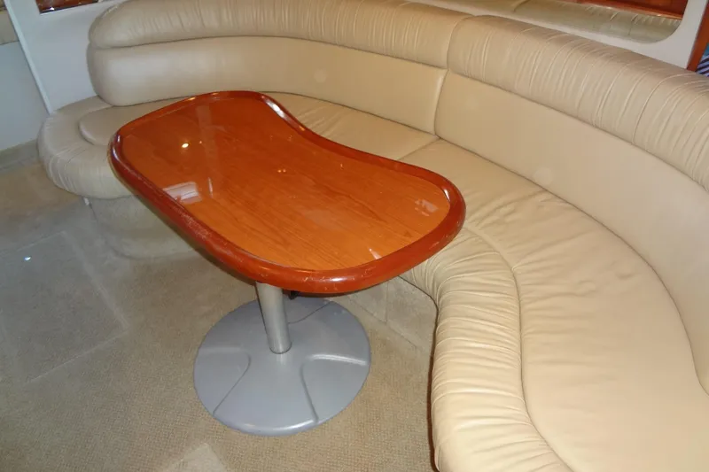 Shel 'b' Gale Yacht Photos Pics Interior of 2001 Sea Ray 380 Sundancer with beige leather seating and wooden table.