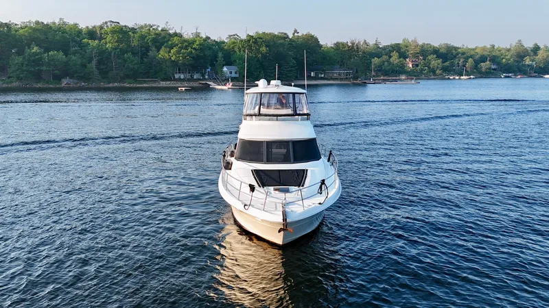 My Satin Doll Yacht Photos Pics 2001 Sea Ray 480 Sedan Bridge yacht cruising on a serene lake.