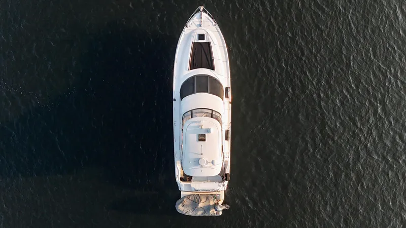 My Satin Doll Yacht Photos Pics Aerial view of 2001 Sea Ray 480 Sedan Bridge yacht on calm water.