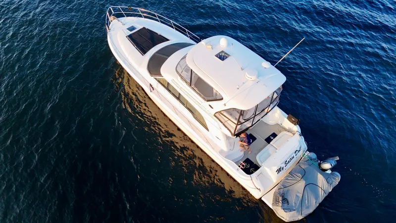 My Satin Doll Yacht Photos Pics Aerial view of 2001 Sea Ray 480 Sedan Bridge yacht on open water.