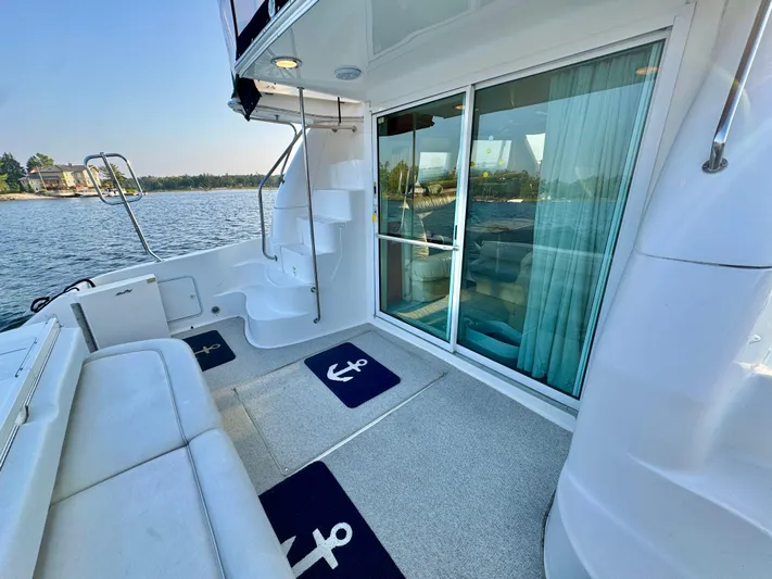 My Satin Doll Yacht Photos Pics 2001 Sea Ray 480 Sedan Bridge yacht deck with seating, stairs, and sliding glass doors.