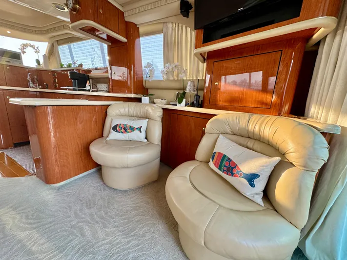 My Satin Doll Yacht Photos Pics Luxurious interior of 2001 Sea Ray 480 Sedan Bridge with plush seating and elegant wood finishes.