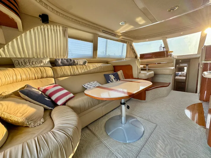 My Satin Doll Yacht Photos Pics Luxurious interior of 2001 Sea Ray 480 Sedan Bridge yacht with plush seating and elegant decor.