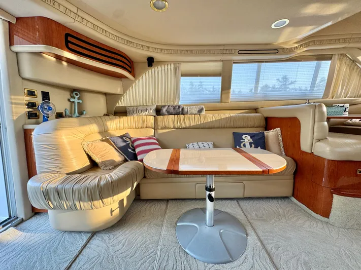 My Satin Doll Yacht Photos Pics Luxurious interior of 2001 Sea Ray 480 Sedan Bridge yacht with plush seating and nautical decor.