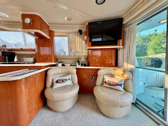 My Satin Doll Yacht Photos Pics Luxurious interior of 2001 Sea Ray 480 Sedan Bridge yacht with plush seating and modern amenities.