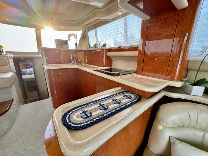 My Satin Doll Yacht Photos Pics Luxurious interior of 2001 Sea Ray 480 Sedan Bridge yacht with elegant wood finishes.
