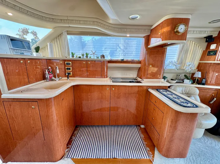 My Satin Doll Yacht Photos Pics Luxurious 2001 Sea Ray 480 Sedan Bridge yacht interior with elegant wood cabinetry and modern amenities.