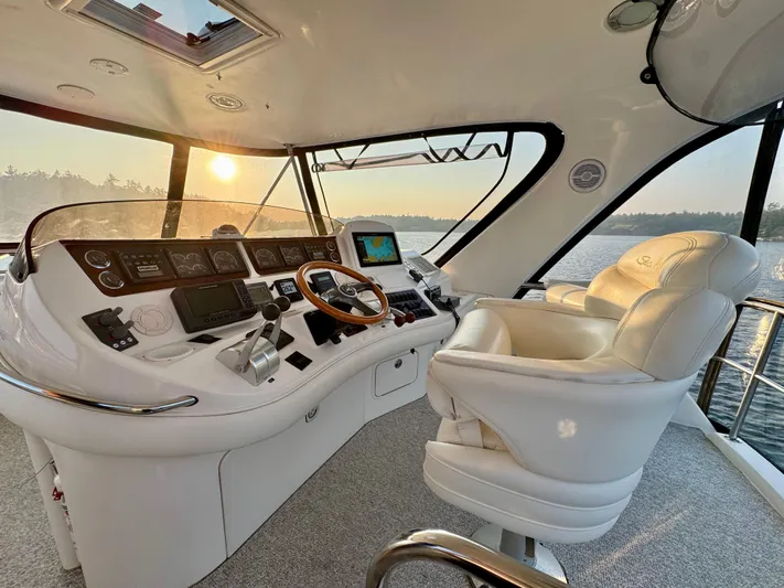 My Satin Doll Yacht Photos Pics Luxurious 2001 Sea Ray 480 Sedan Bridge helm with sunset view over water.