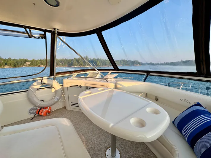 My Satin Doll Yacht Photos Pics Interior view of 2001 Sea Ray 480 Sedan Bridge yacht with scenic water backdrop.