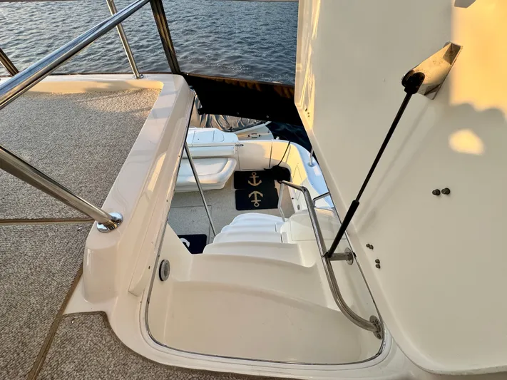My Satin Doll Yacht Photos Pics Staircase on 2001 Sea Ray 480 Sedan Bridge yacht, leading to deck with nautical-themed mat.