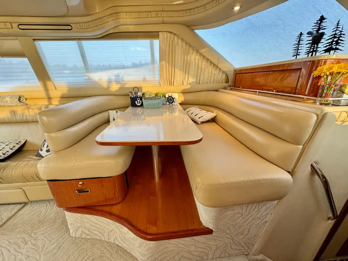My Satin Doll Yacht Photos Pics Luxurious interior of 2001 Sea Ray 480 Sedan Bridge with elegant seating and dining area.