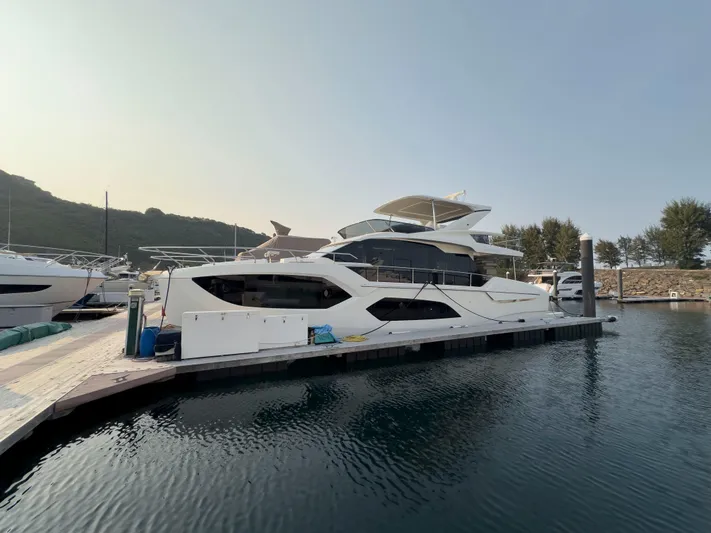  Yacht Photos Pics Luxury 2022 Absolute 60 Fly yacht docked in serene marina setting.