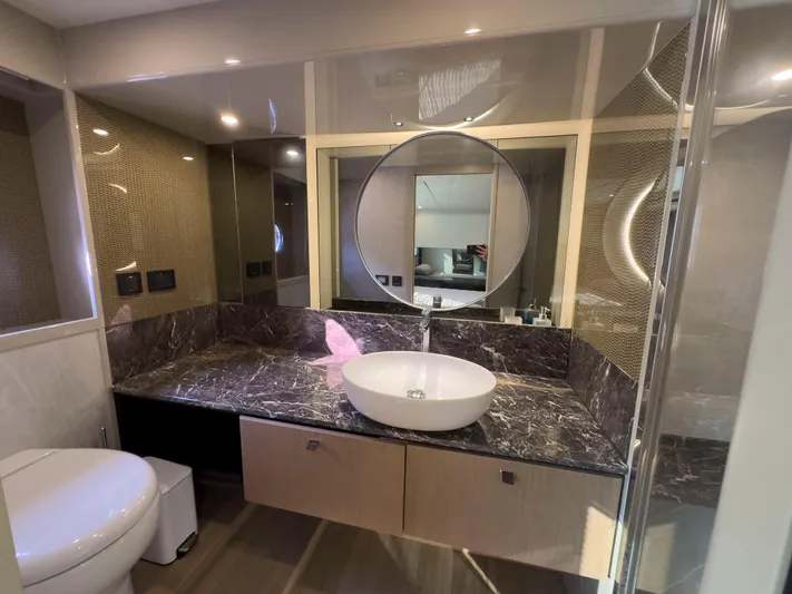  Yacht Photos Pics Luxurious bathroom in 2022 Absolute 60 Fly yacht with modern fixtures and marble countertop.
