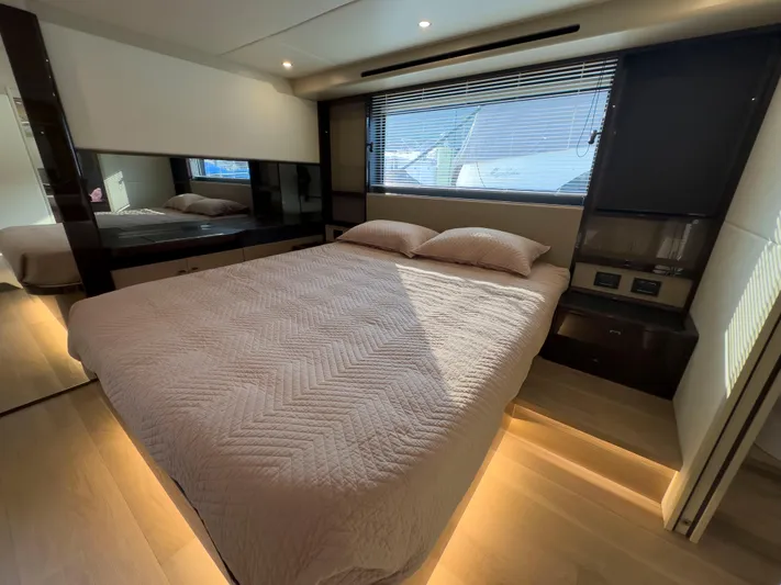  Yacht Photos Pics Luxurious bedroom interior of 2022 Absolute 60 Fly yacht with modern design and ambient lighting.