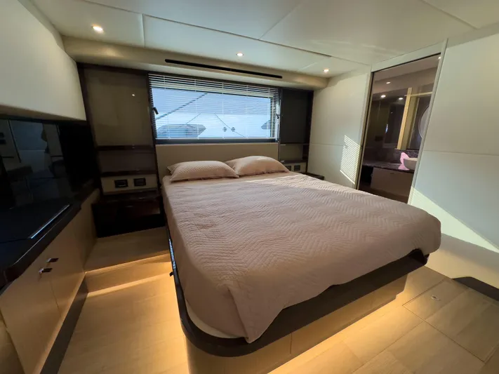  Yacht Photos Pics Luxurious bedroom interior of 2022 Absolute 60 Fly yacht with modern design and ambient lighting.