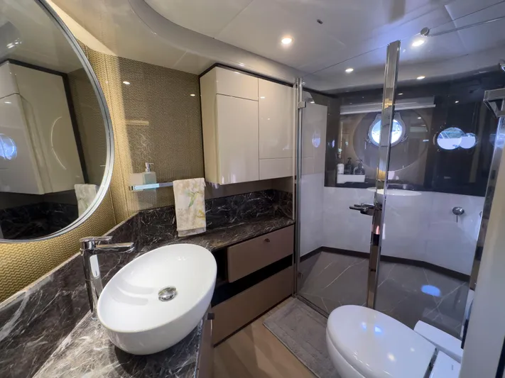  Yacht Photos Pics Luxurious bathroom interior of 2022 Absolute 60 Fly yacht with modern fixtures and elegant design.