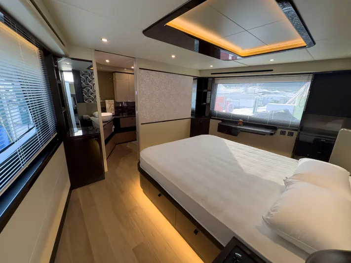  Yacht Photos Pics Luxurious bedroom interior of 2022 Absolute 60 Fly yacht with modern design and ambient lighting.